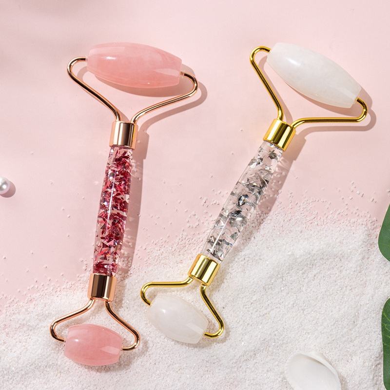 rose quartz facial roller styled with a pearl